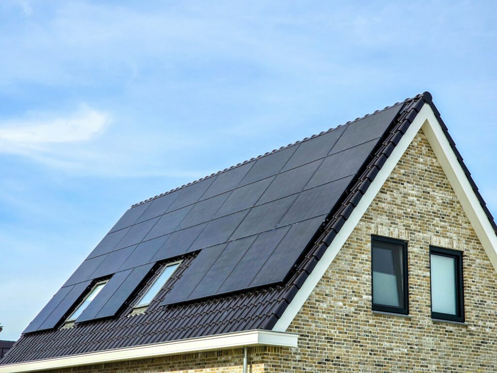 Newly build houses with solar panels attached on the roof against a sunny sky